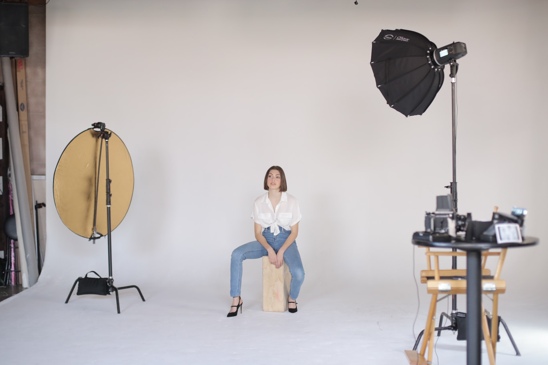 A woman getting ready to have her photo taken at a studio